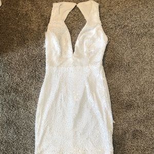Low cut white sequin party dress.